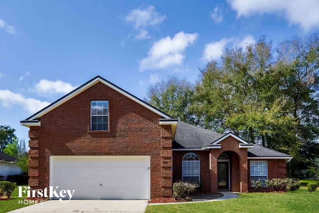 a red brick house with a white garage door