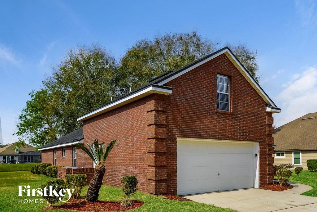 a brick house with a white garage door