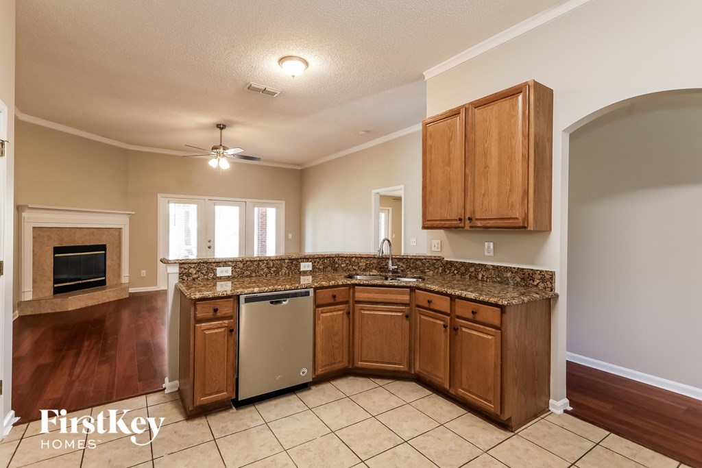 a kitchen with wooden cabinets and granite counter tops