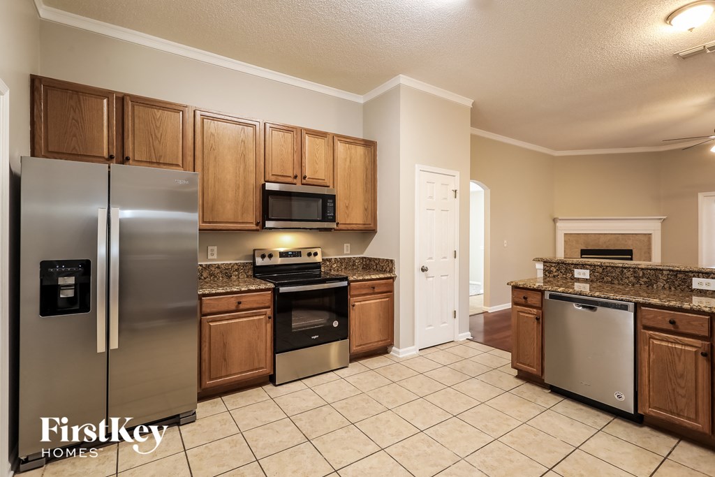 a kitchen with stainless steel appliances and wooden cabinets