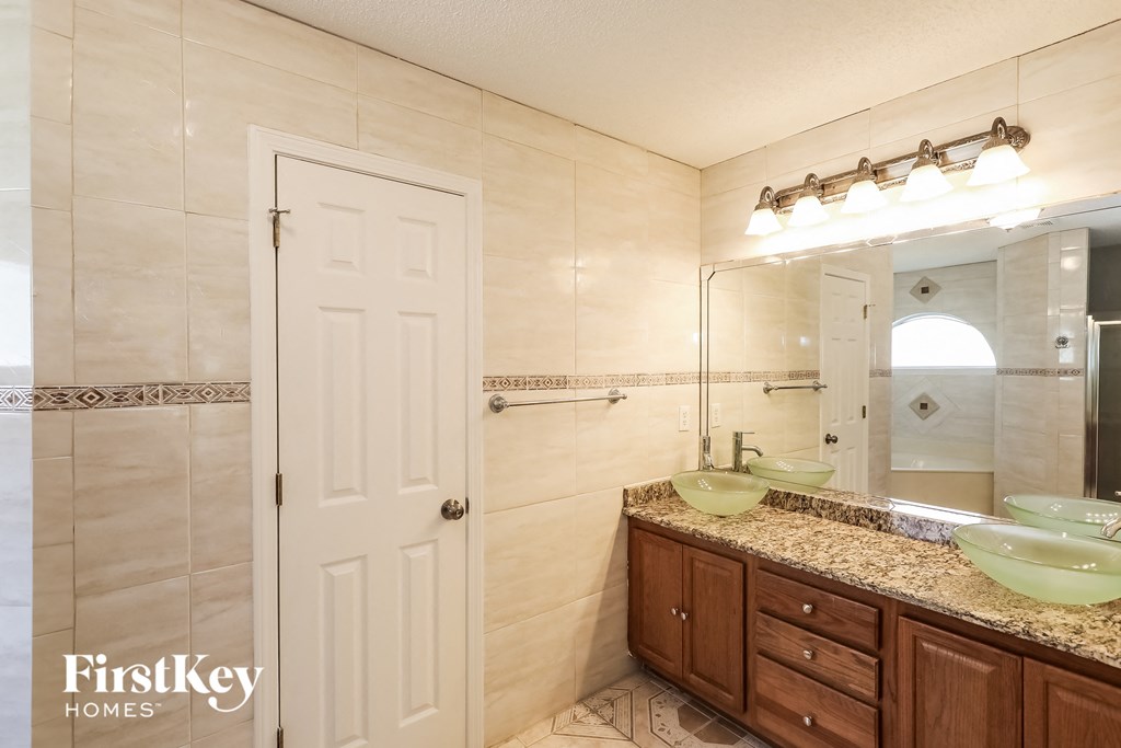 a bathroom with two sinks and a large mirror