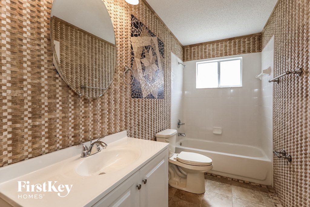 a bathroom with a sink and a toilet and a tub