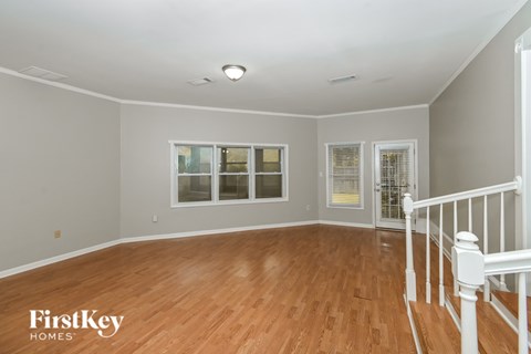 A room with wooden floors and white railings.