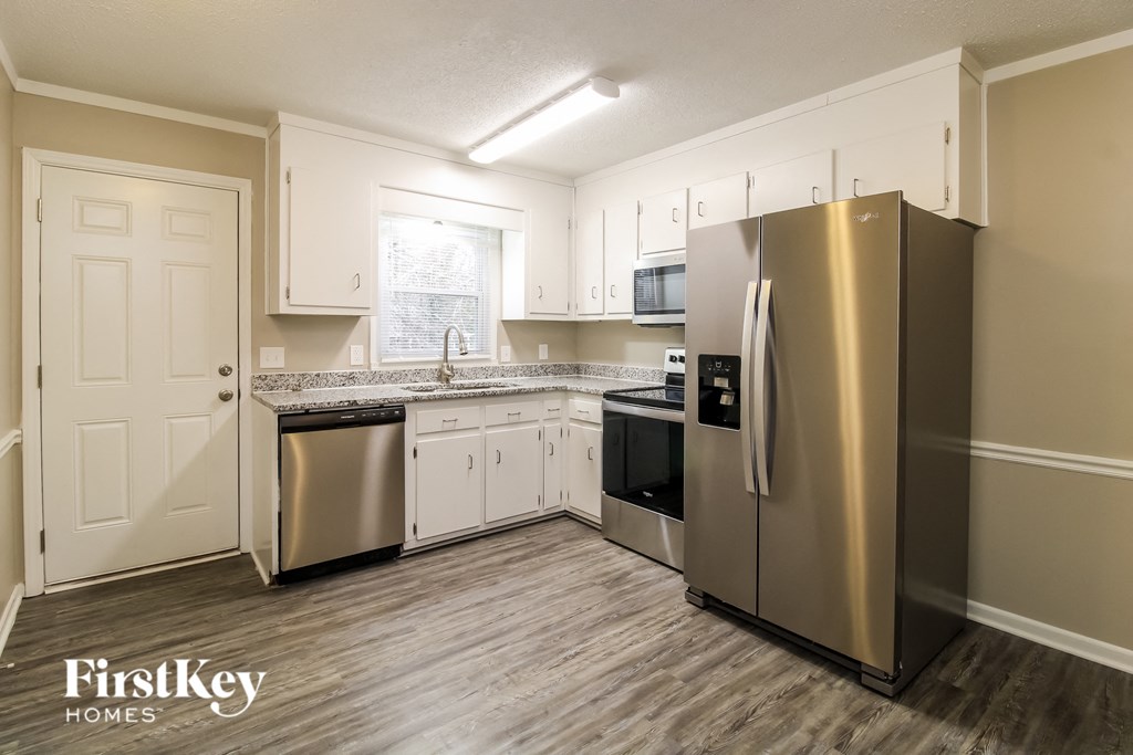 a kitchen with stainless steel appliances and white cabinets