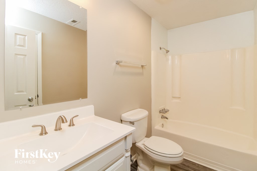 a bathroom with a sink toilet and a bath tub