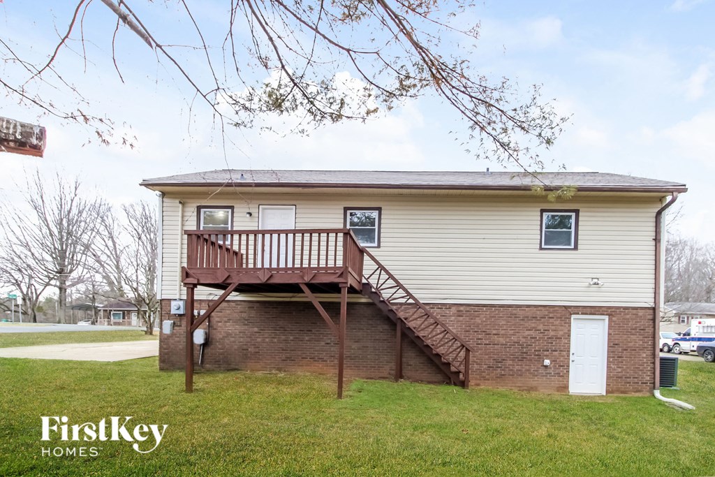 the front of a house with a deck on top of it