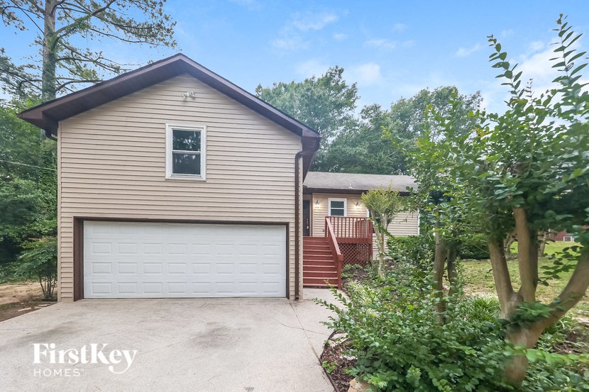 a house with a white garage door and a driveway