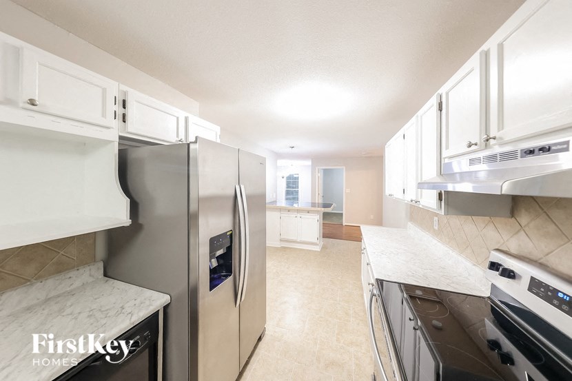 a kitchen with stainless steel appliances and white cabinets