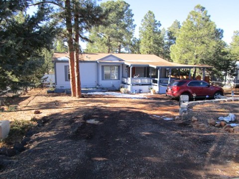 a house with a red car parked in front of it