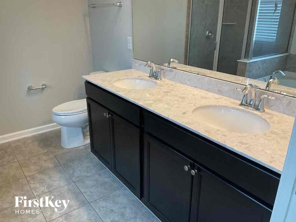 a bathroom with two sinks and a toilet