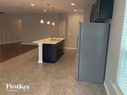 a kitchen with a sink and a refrigerator in a house