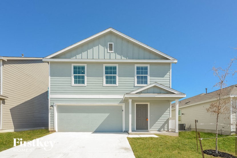a blue and white house with a garage door