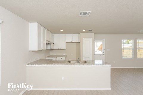 a kitchen with white cabinets and a counter top