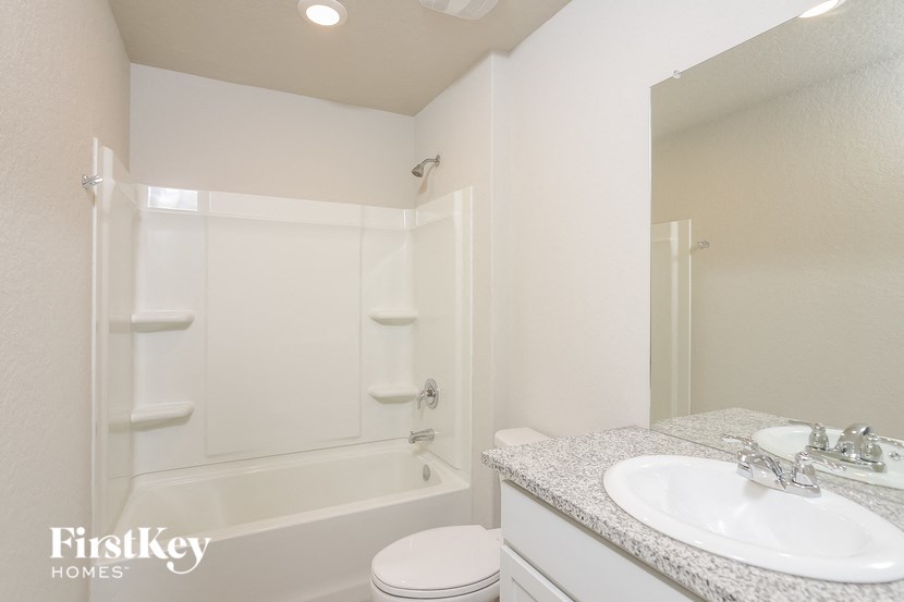 a bathroom with a sink and a shower and a toilet