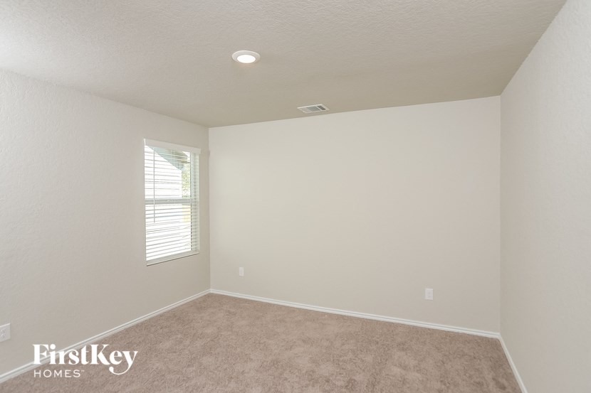 a empty room with white walls and a window
