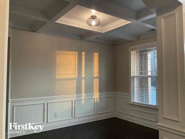 a small room with a white wall and a window