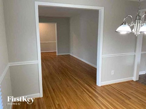 an empty living room with a wood floor