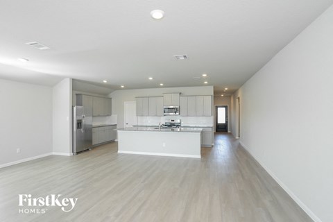 a large white kitchen with white cabinets and a white counter top