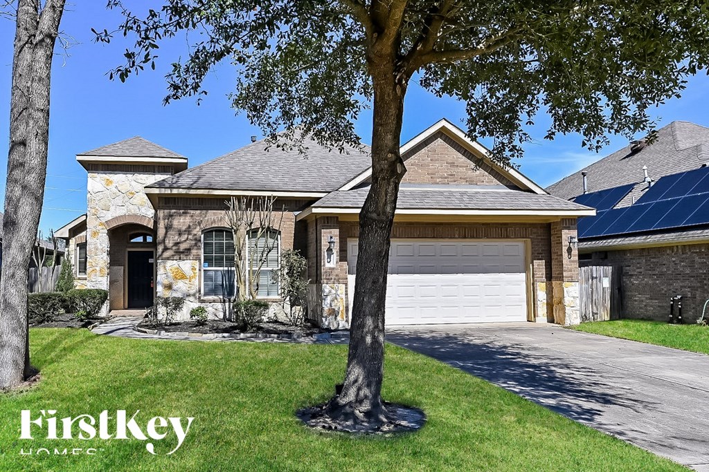 A house with a tree in front of it and the words "FirstKey Homes" on the bottom left.