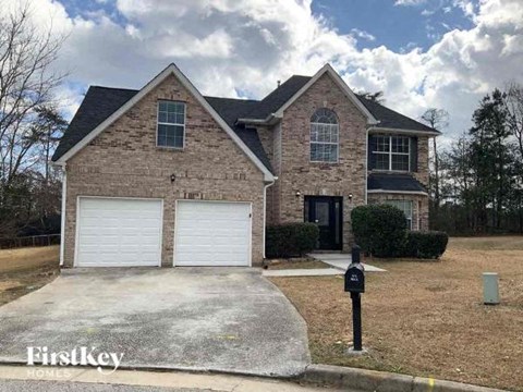 a brick house with two garage doors and a parking meter