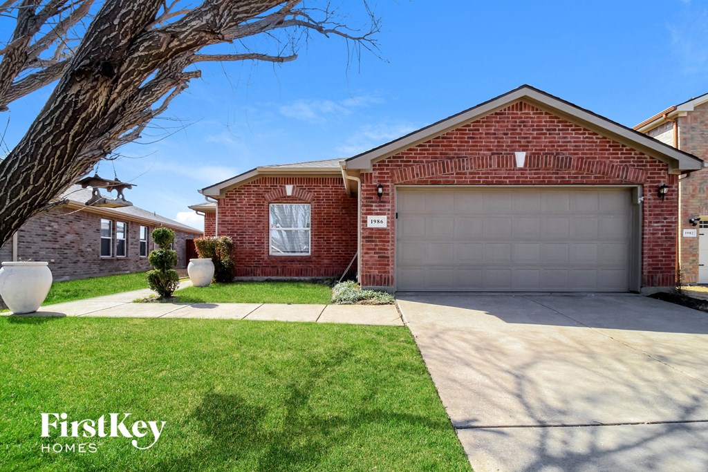 a garage door in front of a brick house