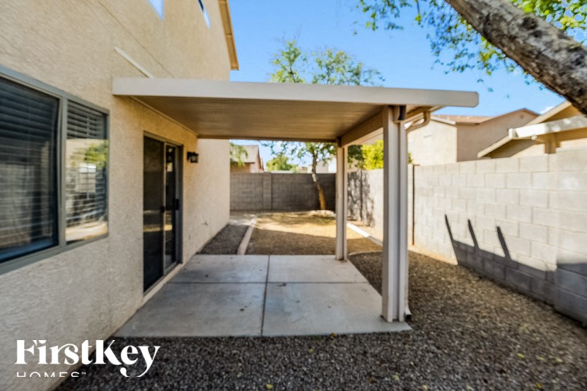 A modern house with a covered walkway leading to the front door.