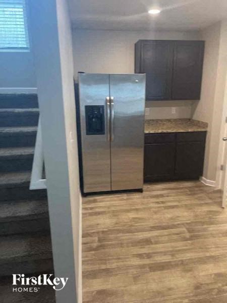 a kitchen with a stainless steel refrigerator in it