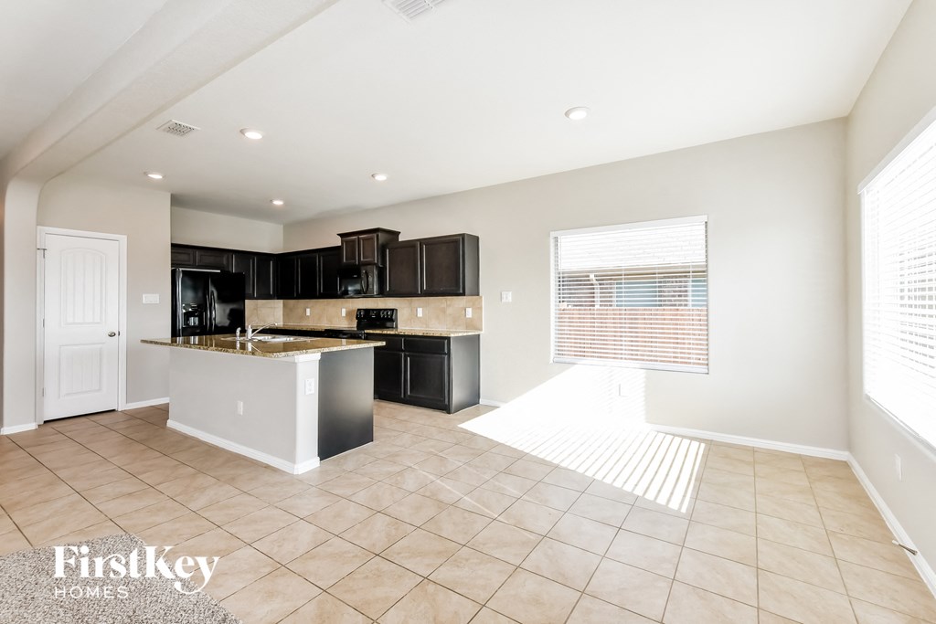 a kitchen with black cabinets and a counter top