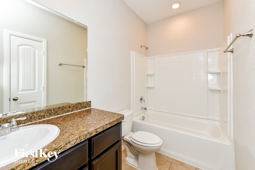 a bathroom with a sink and a toilet and a shower