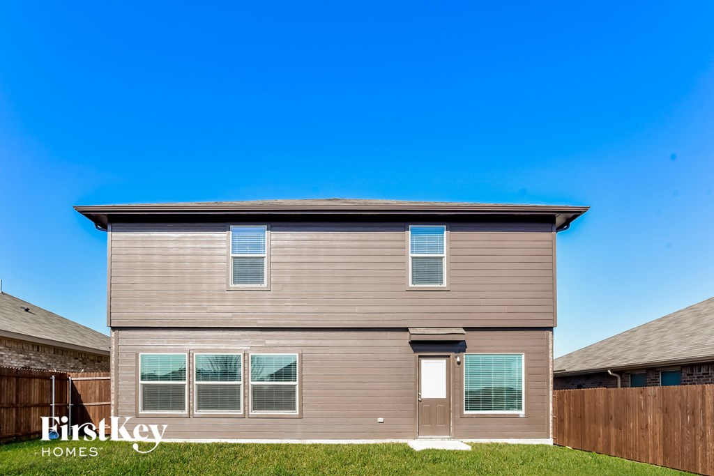 a house with brown siding and a blue sky