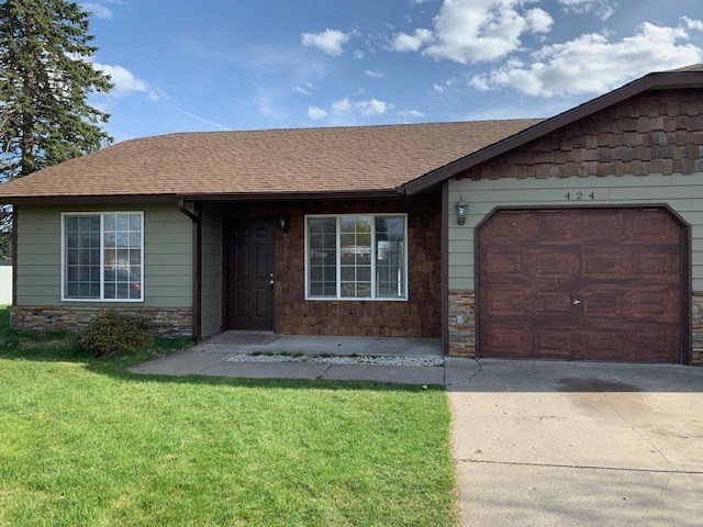 a house with a brown garage door and a sidewalk