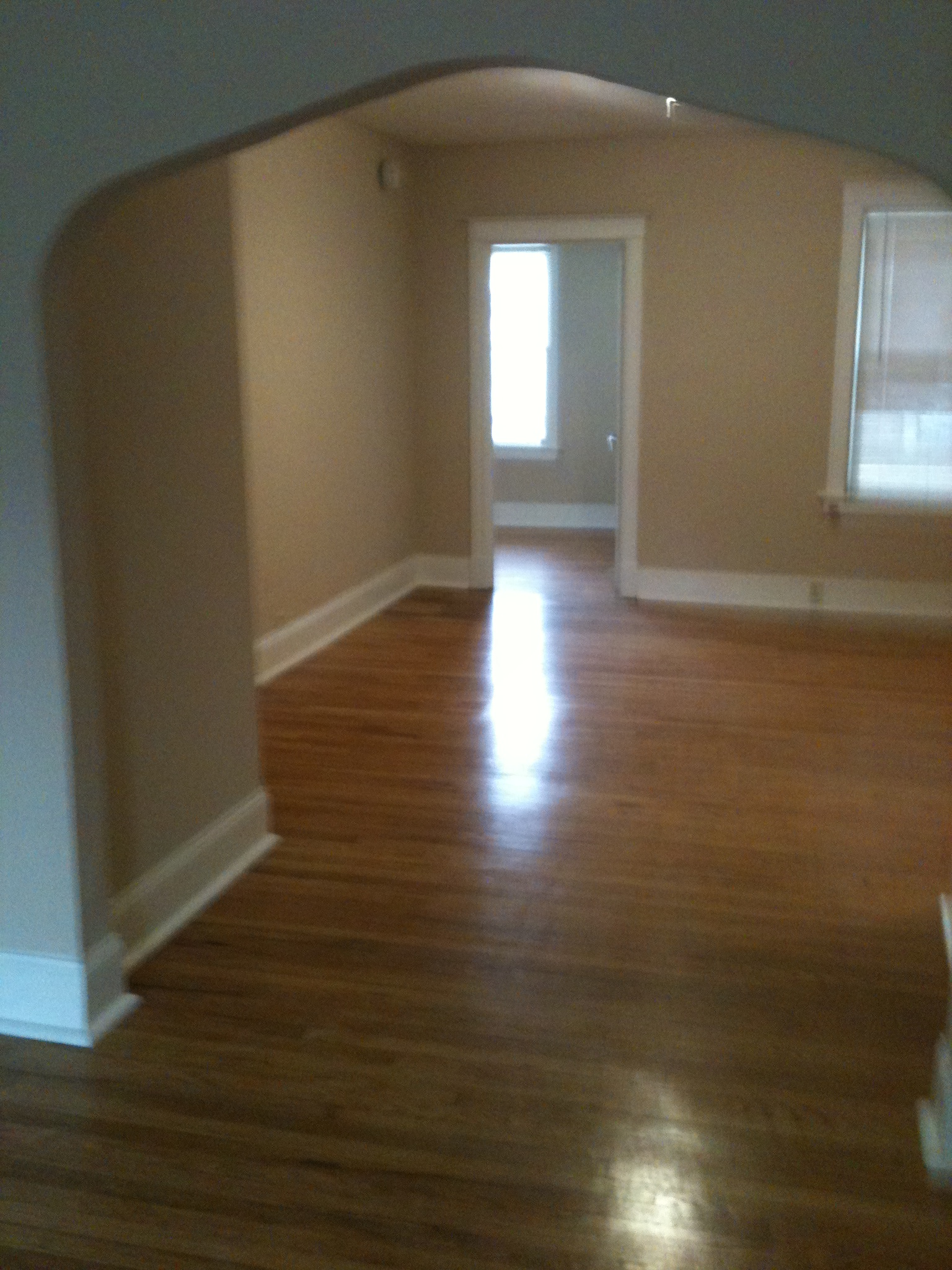 A room with wooden floors and a white door.