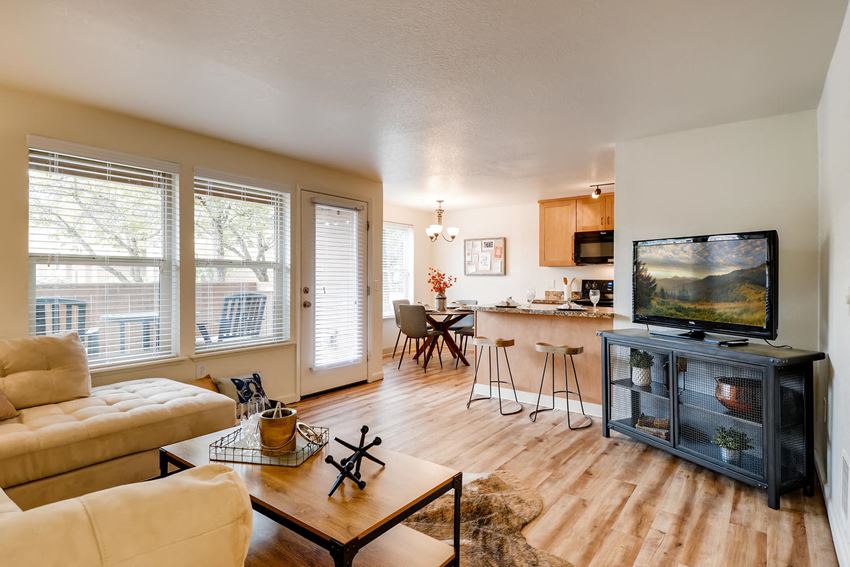 Apartments for Rent in Happy Valley - Sunnyside Village - Living Room with Open-Concept Floorplan, Wood Flooring, and Glass Patio Door - Photo Gallery 1