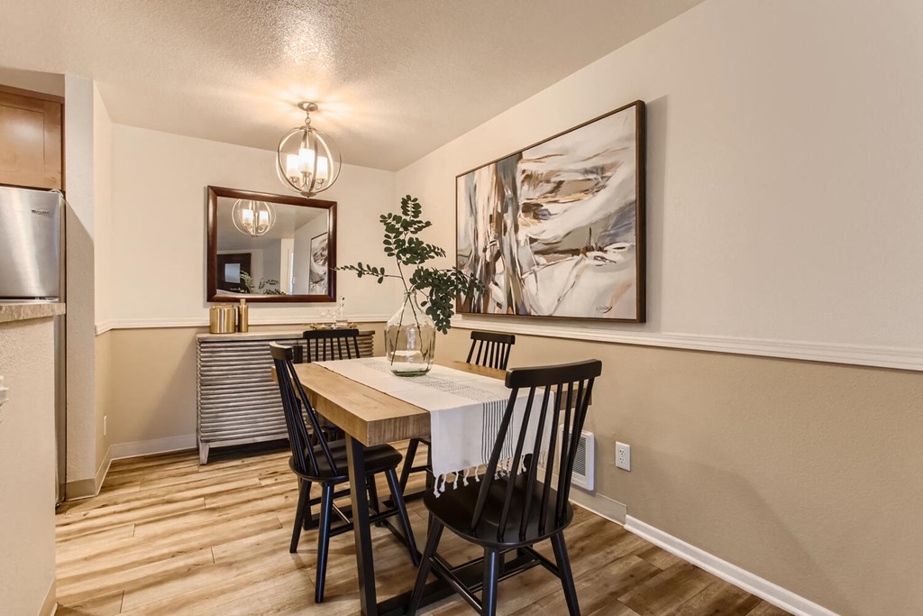 a dining room with a table and chairs