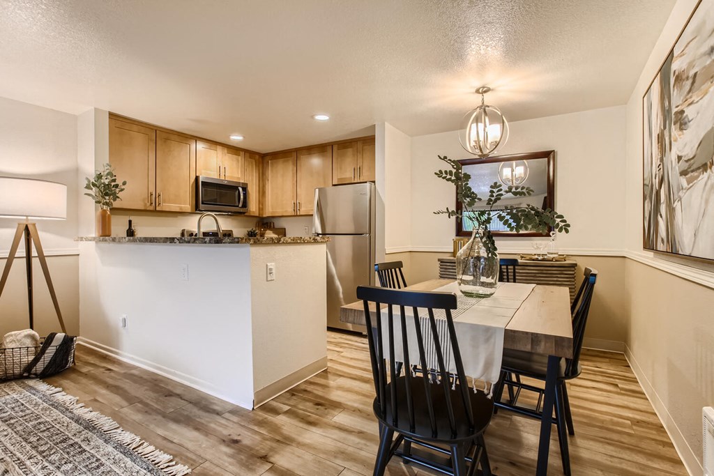 a kitchen and dining room with a table and chairs