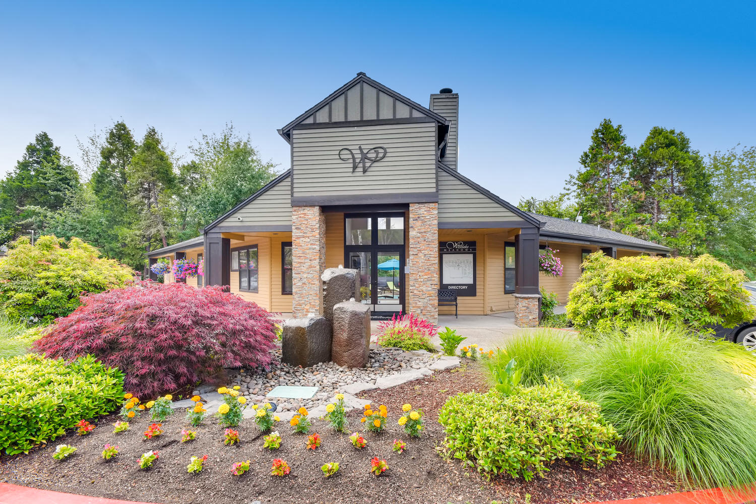 Lake Oswego OR Apartments for Rent - Westlake Meadows - Property Exterior with Brick Details and View of Landscaped Garden and Greens
