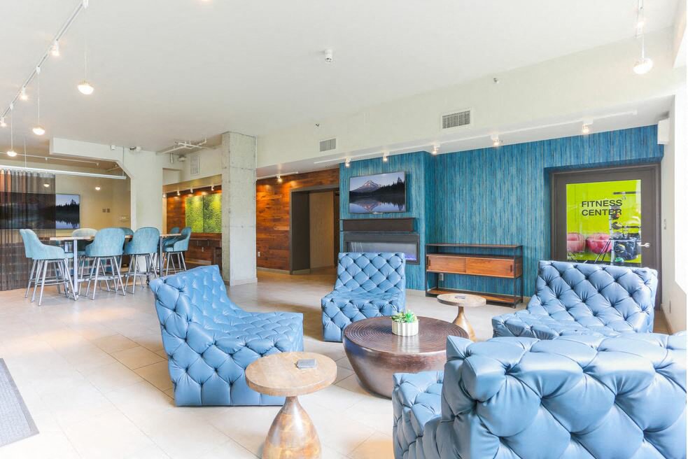 Downtown Portland, OR Apartments - Recreation Lounge With Tile Flooring, Plush Chairs And Couches, Tables, Home Decor, And Near The Fitness Center.