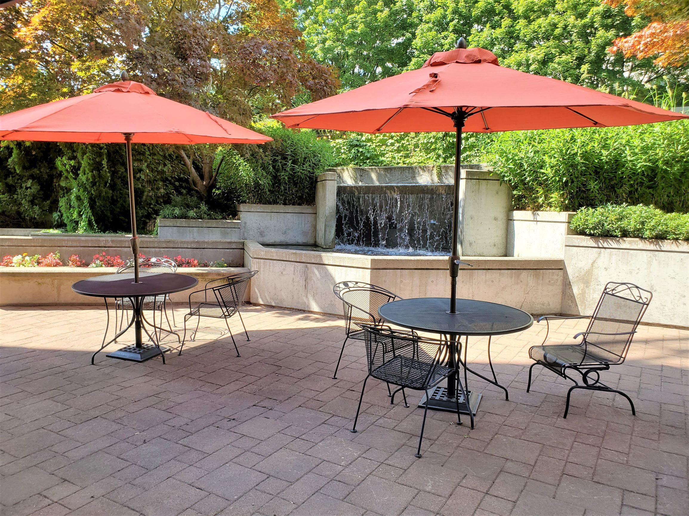 Apartments For Rent In Downtown Portland - Linc301 Outdoor Seating Area with Shaded Tables and Waterfall Fountain Feature