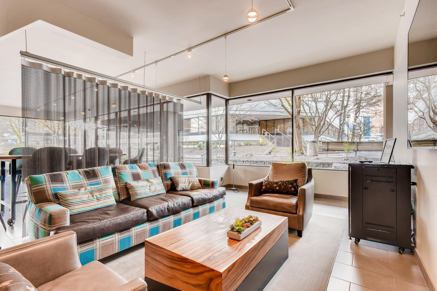 a living room with couches and chairs and a table