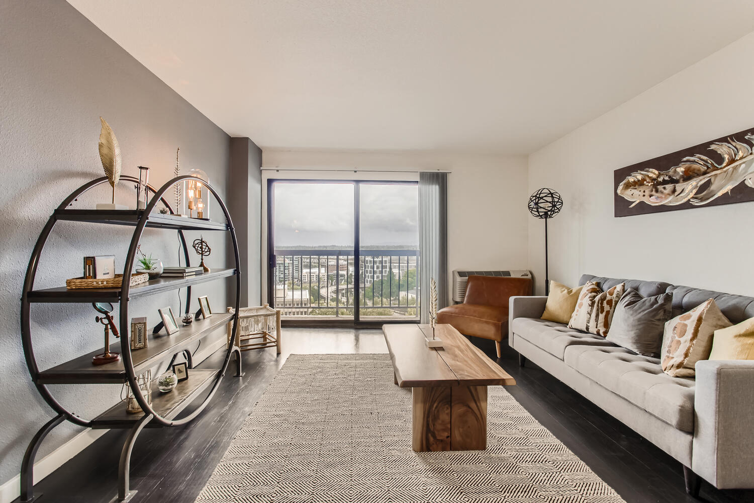 a living room with a couch and a coffee table and a balcony