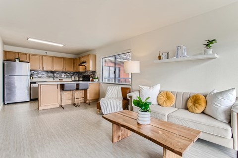 a living room and kitchen with a couch and a table