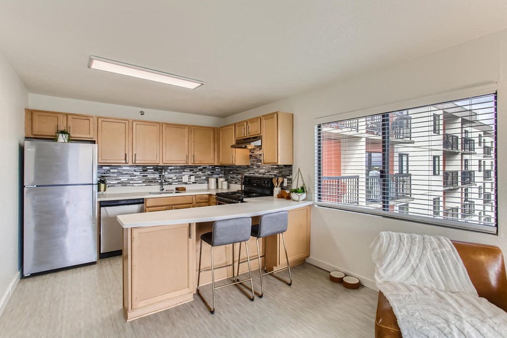 a kitchen with a bar and a large window
