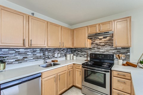 a kitchen with stainless steel appliances and wooden cabinets