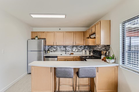 a kitchen with wooden cabinets and a white counter top