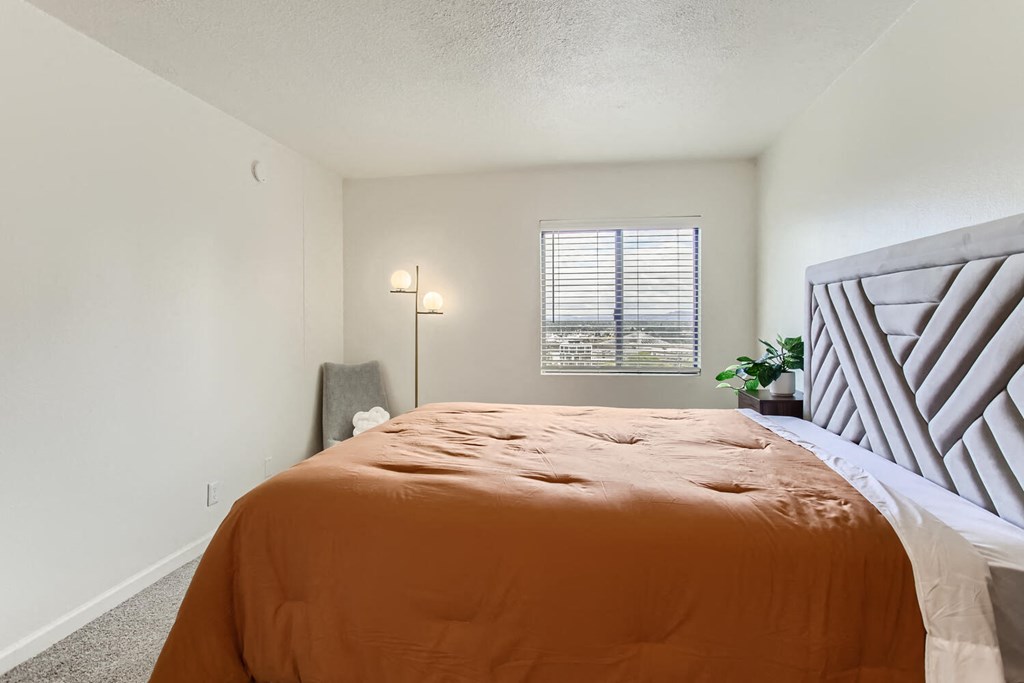 a bedroom with a large bed and a window