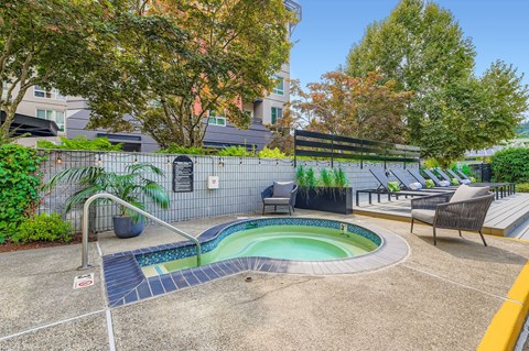 A small pool with a slide and a bench.