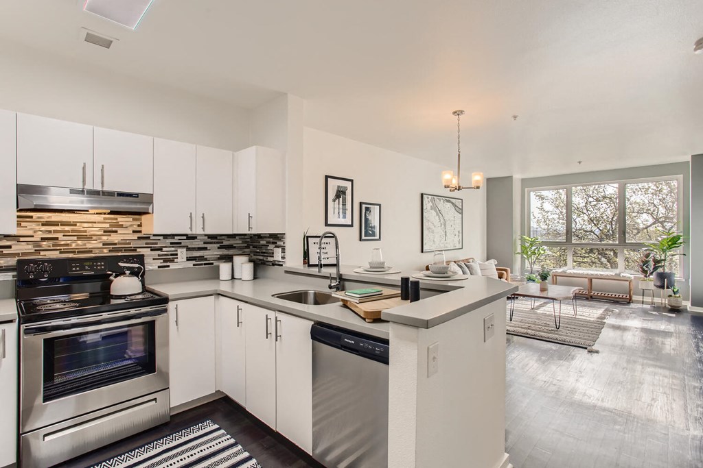 a kitchen with white cabinets and a counter top