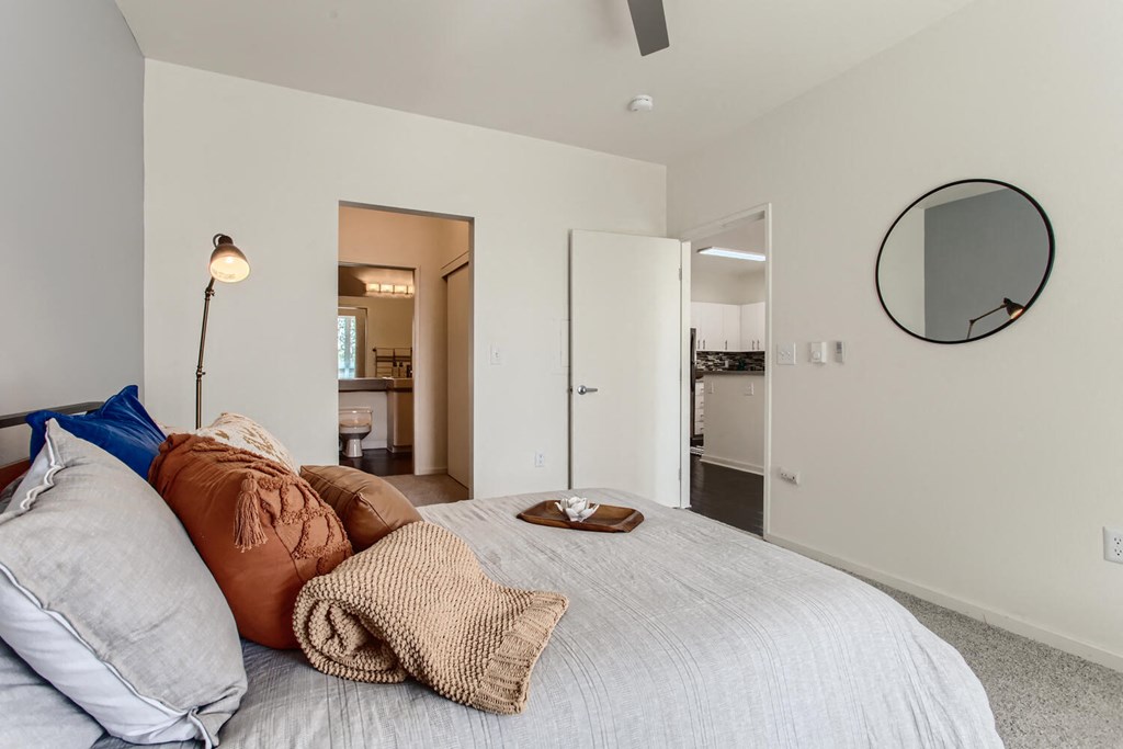 a bedroom with a large bed and a mirror