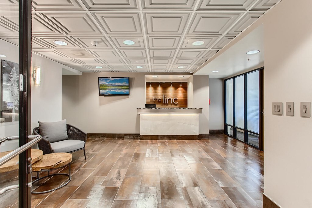 a lobby with a counter and a glass door