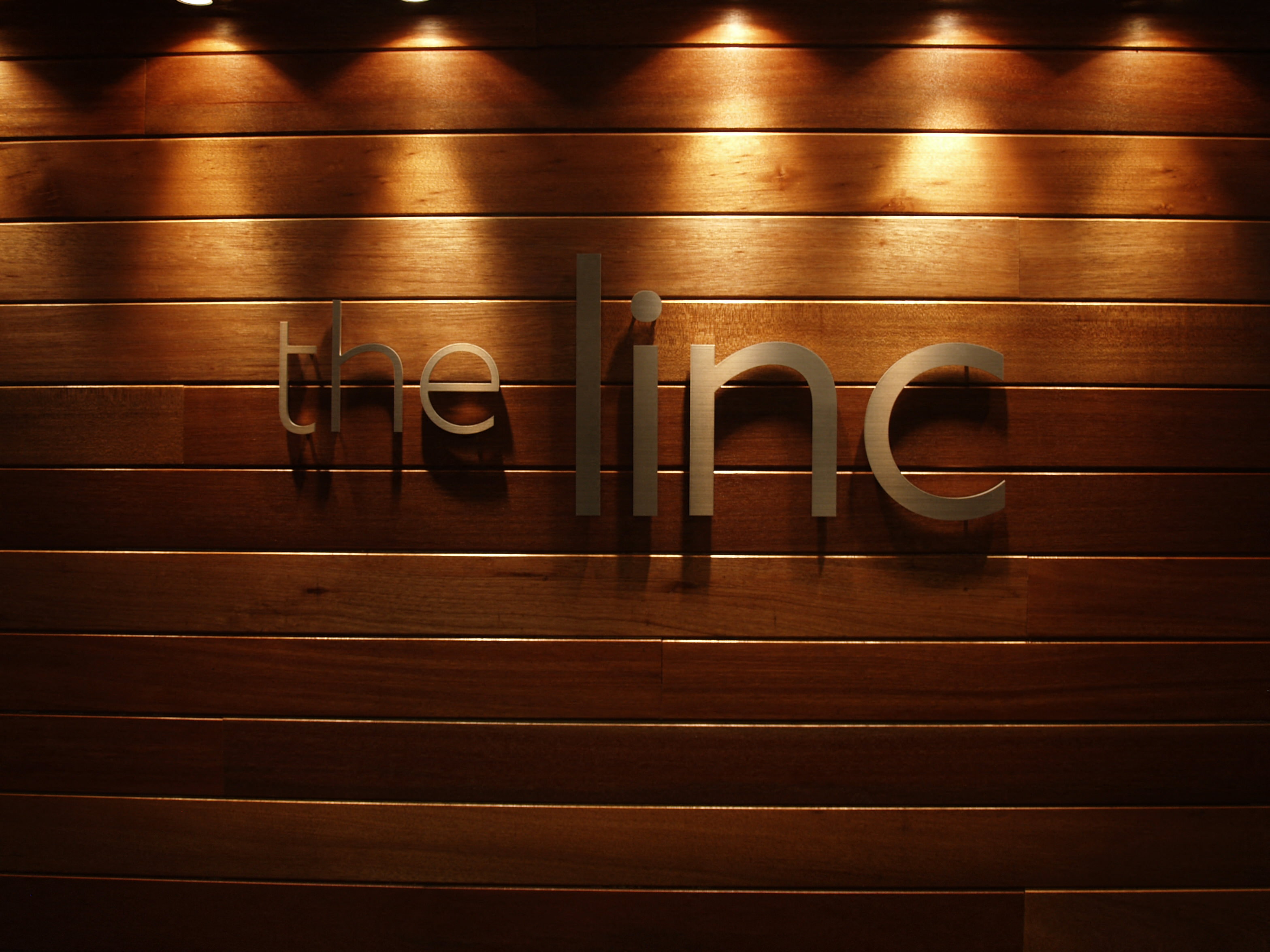 a wooden wall with a company logo on it